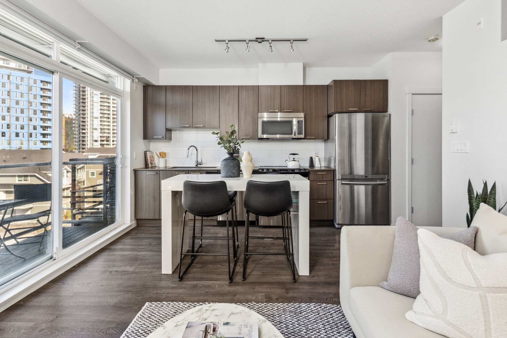 A kitchen with brown wooden cupboards and a white island.
